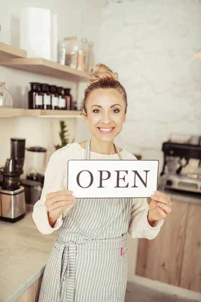 Lächelnde Startup-Inhaberin begrüßt Gäste ihres Cafés. — Stockfoto
