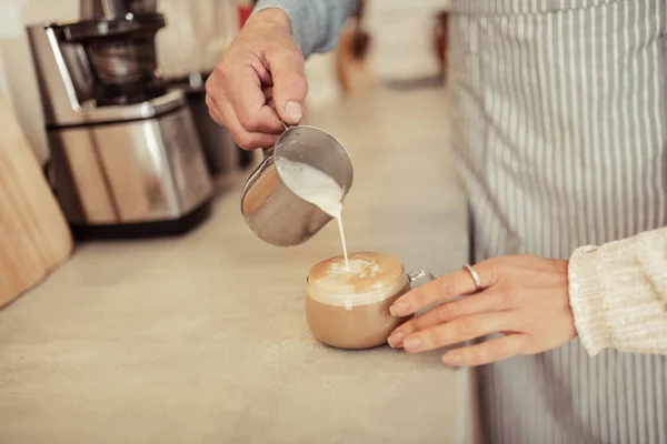 Barista pouring milk into a cup of coffee. — Stock Photo, Image