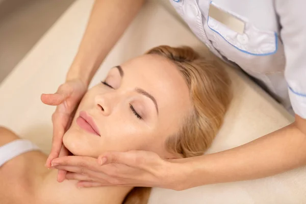 Hermosa joven disfrutando de procedimientos de spa para la cara — Foto de Stock