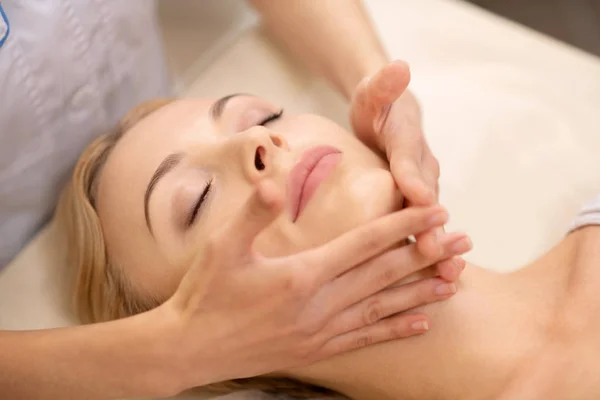 Close up di business donna chiusura occhi godendo di massaggio viso — Foto Stock