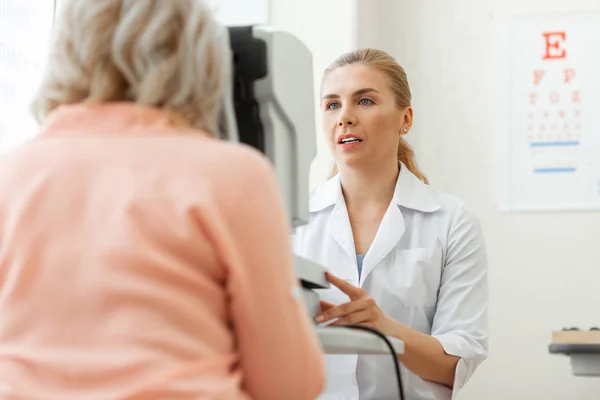 Caring smart blonde doctor being concentrated on computer screen