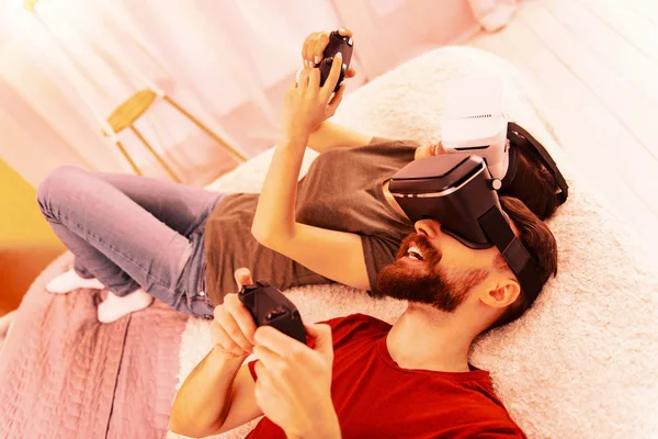 Pretty lady playing a virtual game with a guy
