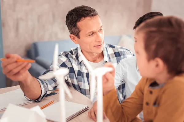 Caring foster father holding pencil in his hand — Stock Photo, Image