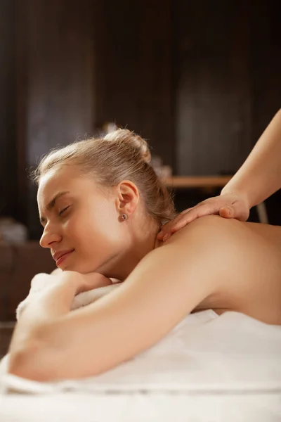 Tranquil blonde lady visiting SPA-complex and getting massage — Stock Photo, Image