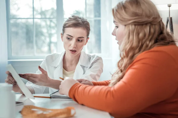 Allvarlig ung sjukvårds anställd som beskriver sitt recept — Stockfoto