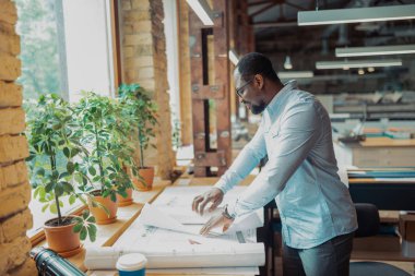 Çizimler yaparken cetvel kullanan sakallı tasarımcı