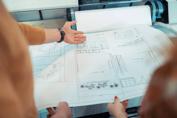 Top view of two interior designers analyzing sketches together — Stock Photo, Image