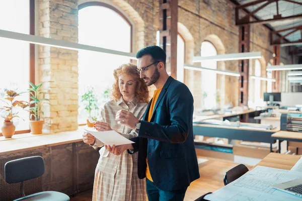 Boss assisteert zijn interieur ontwerper tijdens het maken van schetsen — Stockfoto