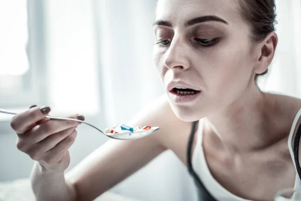 Portrait of serious female that holding spoon in right hand — Stock Photo, Image