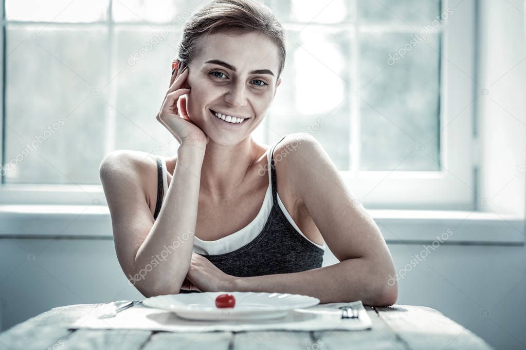 Pleased brunette woman demonstrating her sincere smile