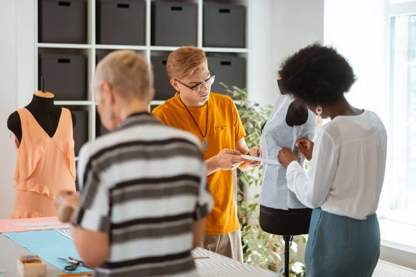 Female fashion designers working with a male colleague