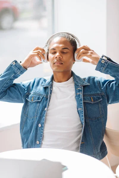 Relajado joven hombre usando sus auriculares — Foto de Stock