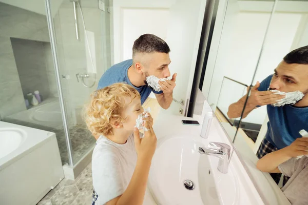 Bonito padre barbudo enseñando a su hijo a afeitarse — Foto de Stock
