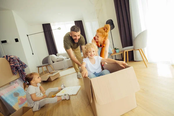 Nice blonde boy sitting in the box — Stock Photo, Image