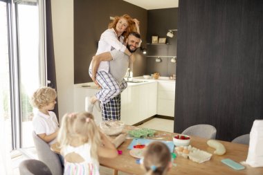 Neşeli mutlu adam sırtında karısını taşıyan