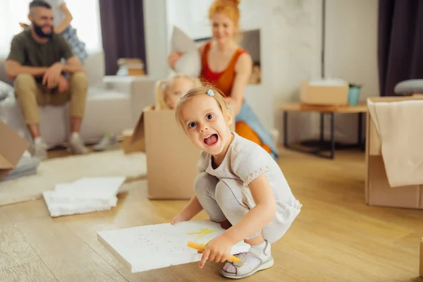 Cute pretty girl holding her drawing in the hand — Stock Photo, Image