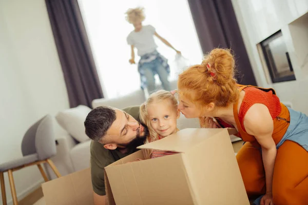 Nice loving parents wanting to kiss their daughter — Stock Photo, Image