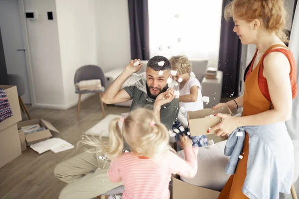 Радостная счастливая семья играет с пластиковой пеной — стоковое фото