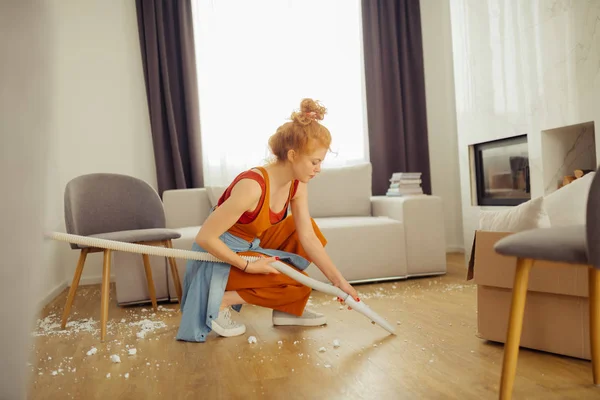 Trevlig trevlig kvinna rengöra golvet i huset — Stockfoto