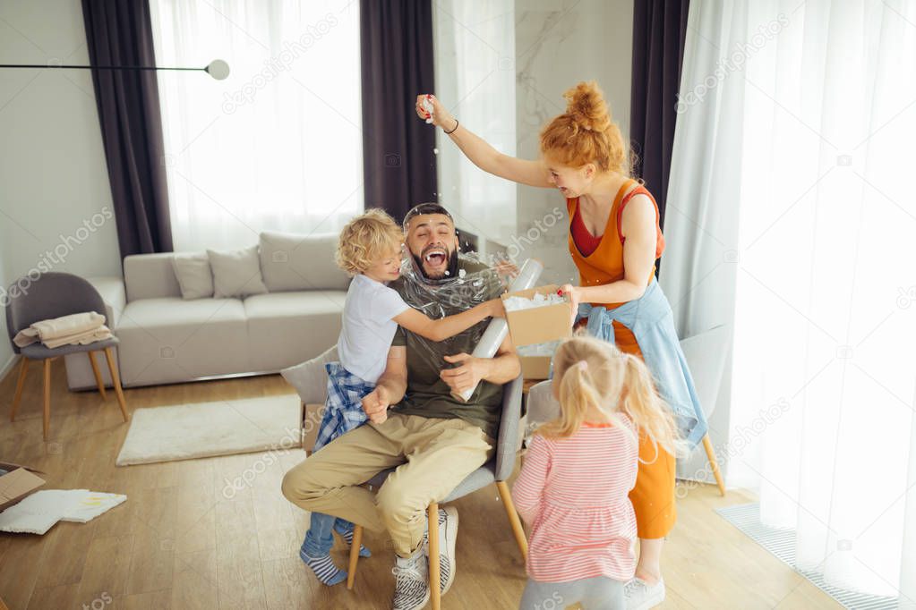 Joyful nice family playing funny games together