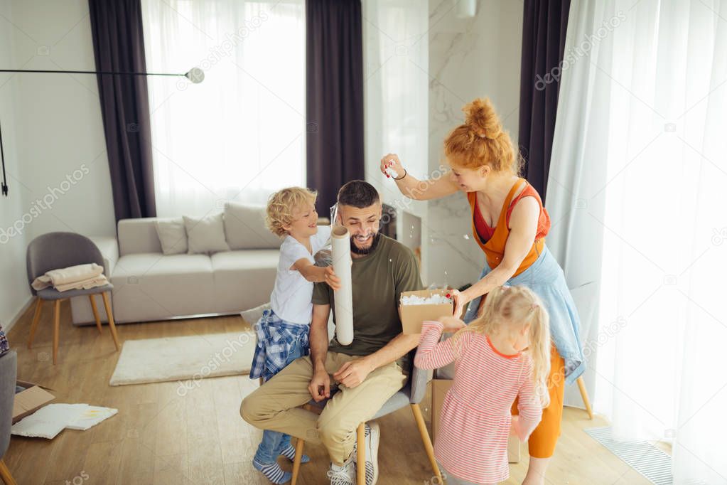 Cheerful nice man enjoying time with his family