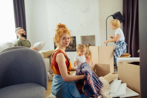 Nice red haired woman holding a plaid — Stock Photo, Image