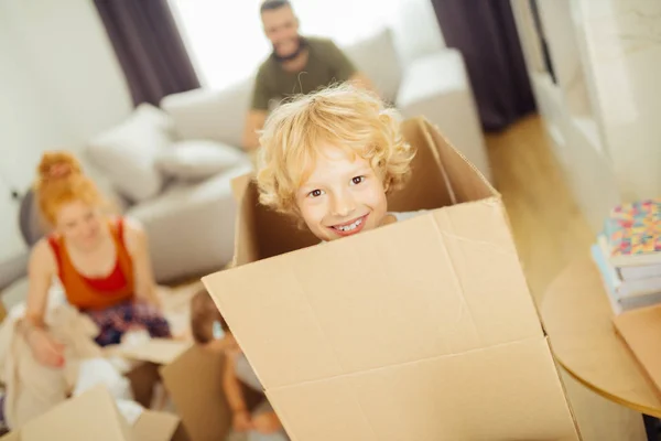 Cute nice blonde boy looking from the box — Stock Photo, Image