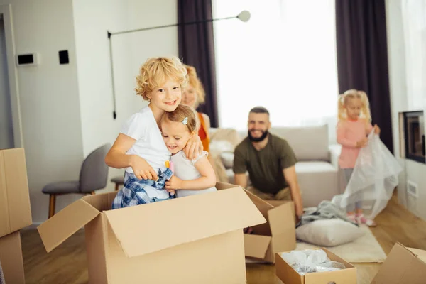 Positive blonde boy hugging his younger sister — Stock Photo, Image