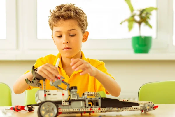 Serious good looking boy being engaged in the activity — Stock Photo, Image