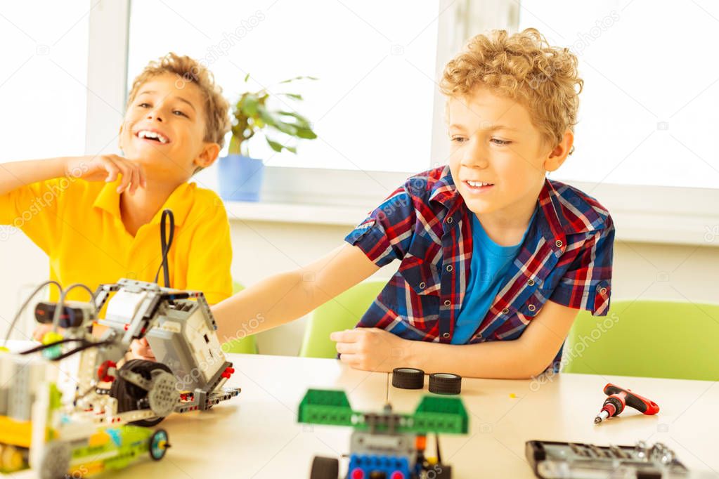 Delighted cute boys being interested in robotics