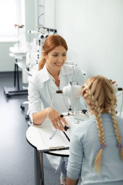 Masada oturan hasta ve göz doktorunun üst görünümü