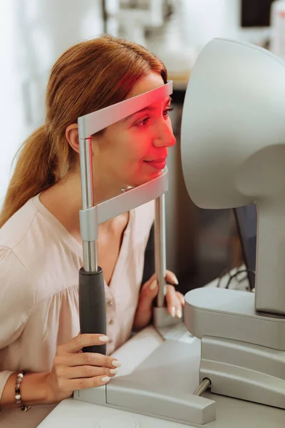 Woman wearing stylish blouse having eyes diagnostics