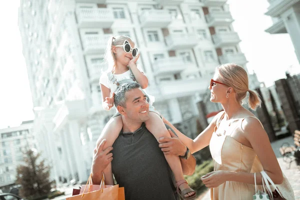 Little girl talking to her parents on the walk. — Stock Photo, Image