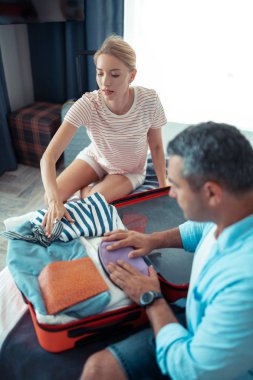 Kadın kocası seyahat çantası paketleme yardım.