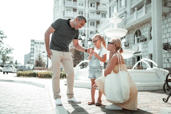 Little girl talking with her parents in the street. — Stock Photo, Image