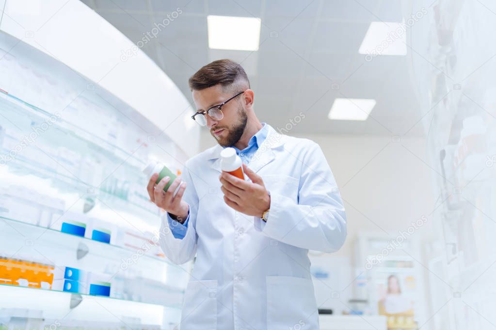 Serious bearded male person wearing in drug store