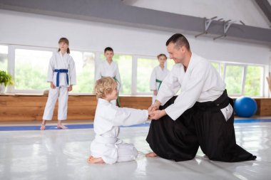Onun aikido eğitmen ellerini sallayarak ve gülümseyen Çocuk Işınlama