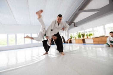 Eğitmen beyaz kimono giyen kız ile atmak pratik