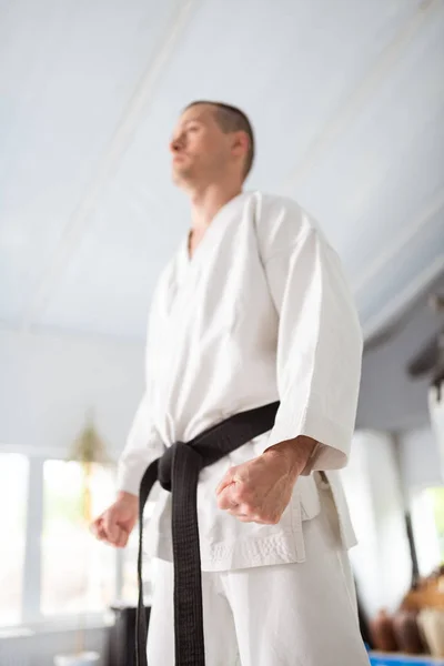 Serious aikido master wearing kimono with black belt — Stock Photo, Image