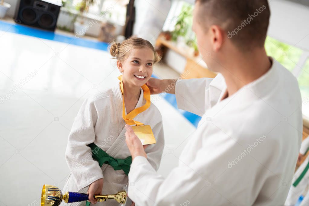 Cheerful girl loving kimono smiling while receiving prizes