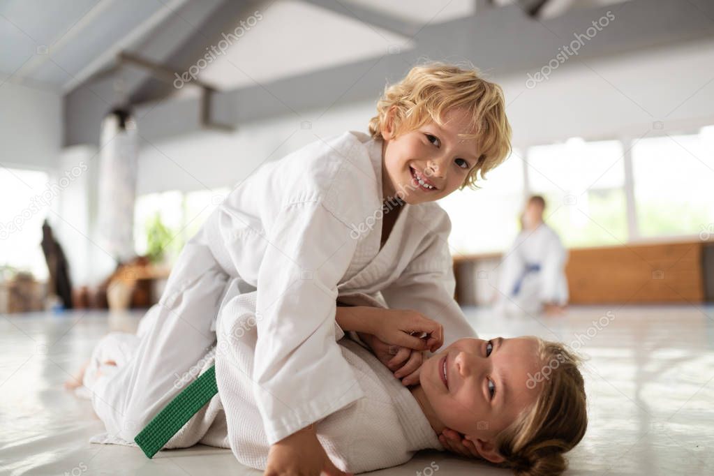 Brother and sister feeling joyful doing aikido together