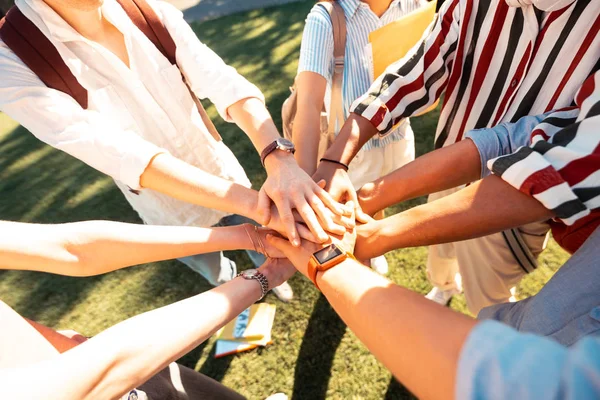 Hands of groupmates lying one on another. — Stock Photo, Image