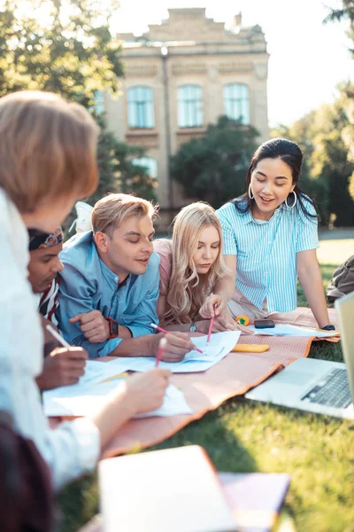 Students doing their homework in the fresh air.