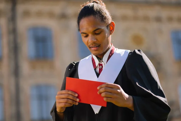 Smiling boy delivering a speech during the graduation.