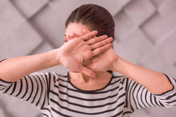 Young woman covering her face with palms — Stock Photo, Image