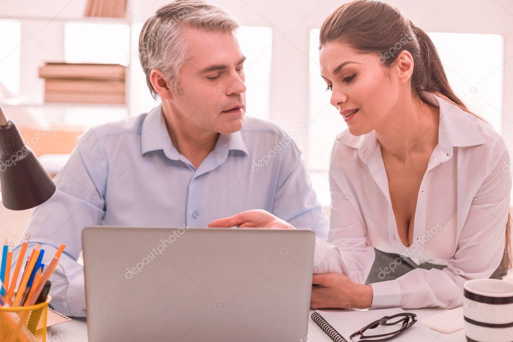 Man is distracted by looking at his young female colleague