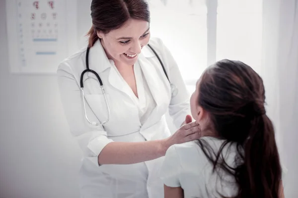 Entzückte Kinderärztin blickt auf ihre Patientin — Stockfoto