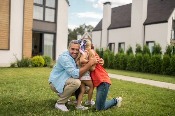 Parents hugging their little lovely daughter outside — Stock Photo, Image