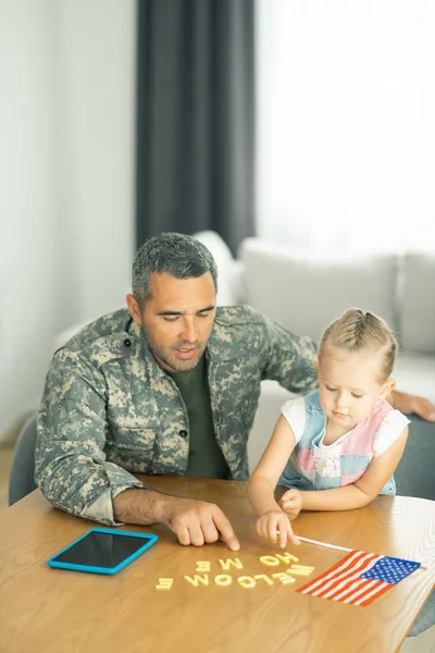 Military man coming back home and playing with daughter