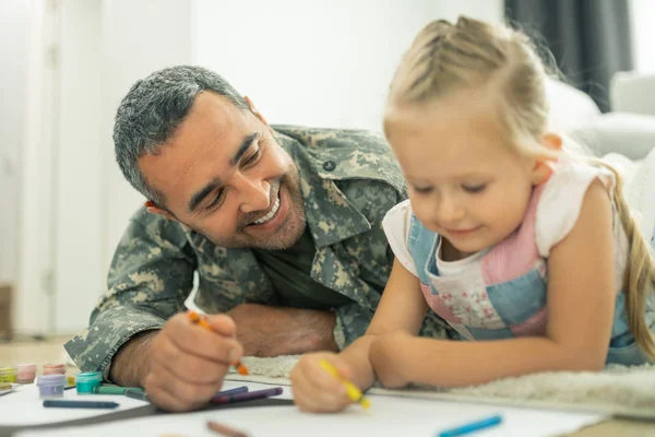 Papa lächelt beim Bemalen des Stammbaums mit Tochter — Stockfoto